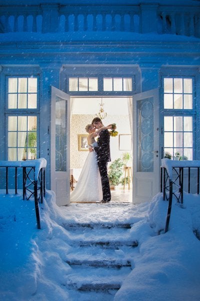 This couple looks cozy in love as the snow rages outside in a shot that captures both the warmth and the cold.