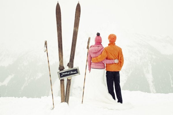 From the wooden skis and poles to the bright puffer jackets and beanie hats, we’re in love with this ski bunny couple.