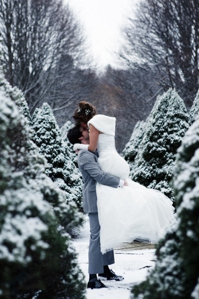 <p>As if this couple needs more joy, frosted evergreens bring a bit of wintry merriment, their set-up perfectly framing this happy couple.</p>