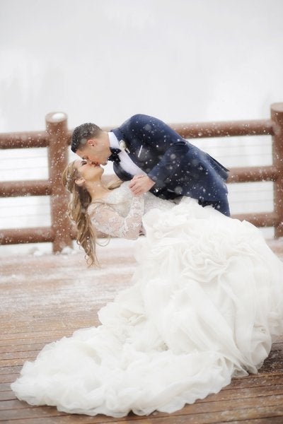 <p>Have you ever seen a <a href="http://www.bridalguide.com/planning/the-details/photo-video/wedding-kiss-photos#164259" target="_blank">kiss as romantic</a> as this one? All we can say is, "Let it snow."</p>
