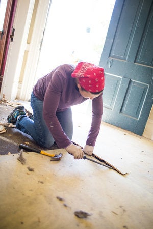 A volunteer works on renovations of the property that will house Encircle.