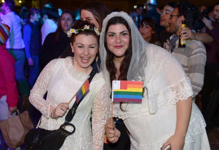 People celebrate in Saint George's Square after the Maltese parliament approved a civil unions bill in Valletta on April 14, 2014.