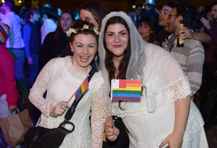 People celebrate in Saint George's Square after the Maltese parliament approved a civil unions bill in Valletta on April 14, 2014. 