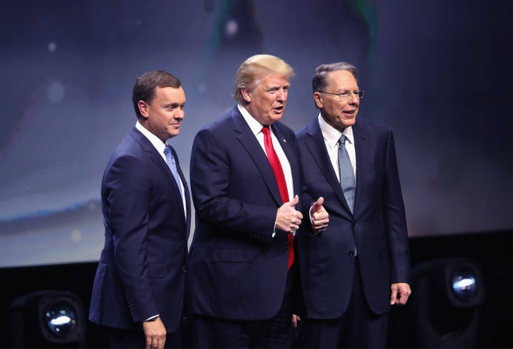 Republican presidential candidate Donald Trump is introduced with Chris Cox (L), Executive Director of the NRA Institute for