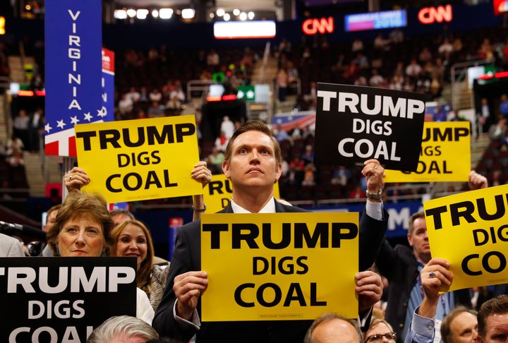 Delegates from West Virginia hold signs supporting coal on the second day of the Republican National Convention in Cleveland, Ohio, July 19, 2016.