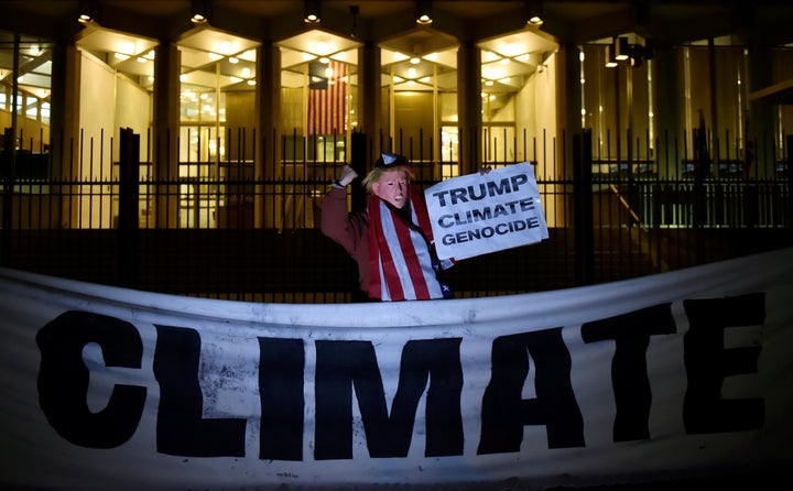 A man wearing a Trump mask protests during a demonstration against climate change outside the U.S. Embassy in London in November.