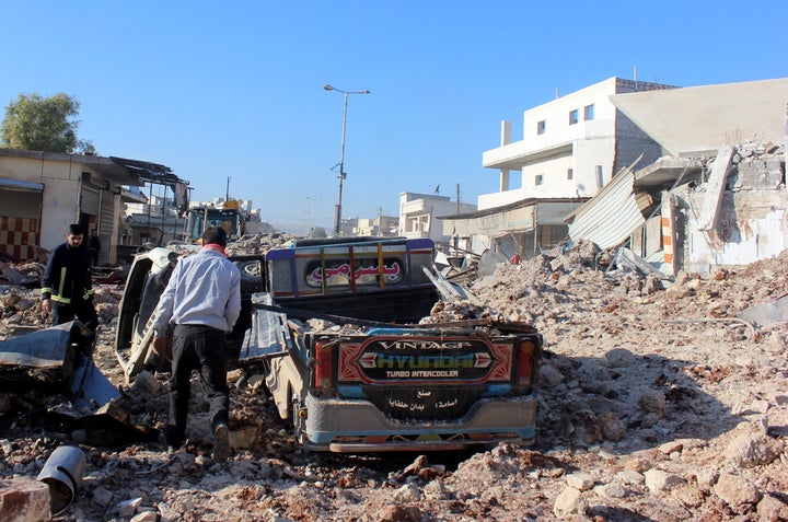 Civil defense team members carry out search and rescue works after the war crafts belonging to the Syrian Army bombed the bazaar in the Etarib district of Aleppo, Syria on December 6, 2016.