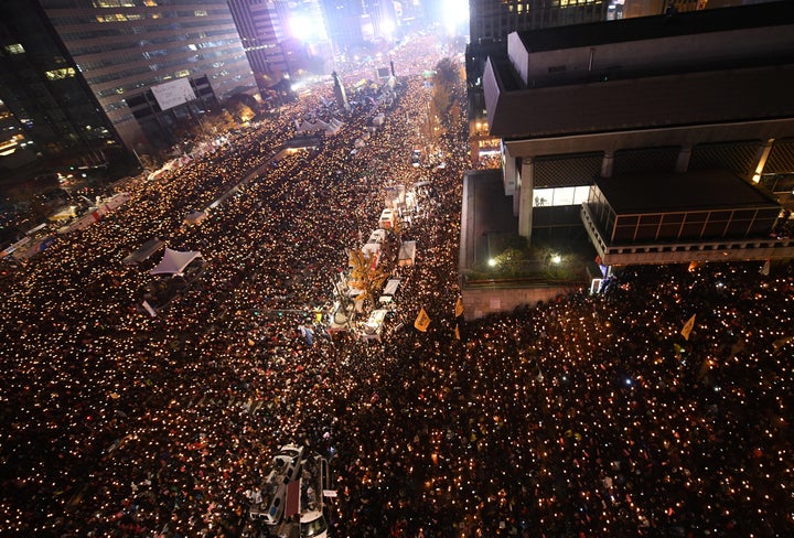 Protesters hold candles during an anti-government rally in central Seoul on Nov. 19, 2016, aimed at forcing South Korean President Park Geun-Hye to resign over a corruption scandal.