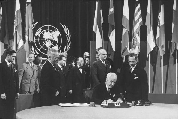The United States officially Signs the UN Charter. President Harry S. Truman looks on from left.
