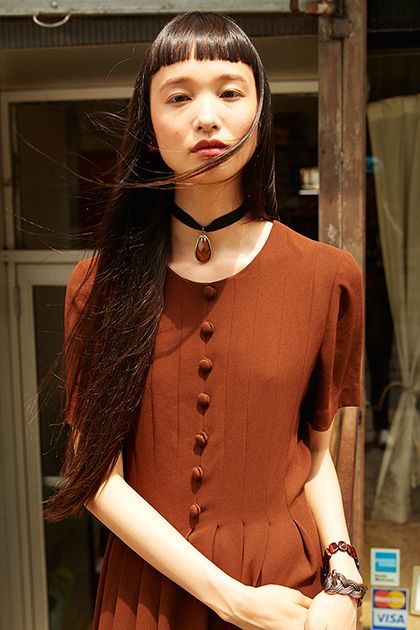 <p><em>Model’s own dress and jewelry.</em></p>