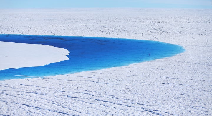 Water is seen on part of Greenland's glacial ice sheet, July 2013.