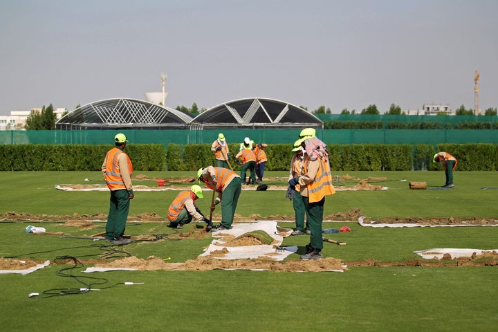 Workers test soil as they grow grass for Qatar's 2022 World Cup, at an experimental facility in Doha, Qatar November 29, 2016
