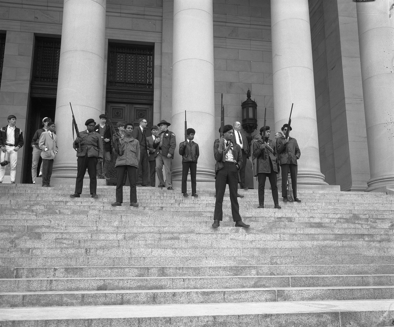 Armed members of the Seattle chapter of the Black Panther Party standing on the state capitol steps protesting a proposed law limiting the ability to carry firearms in a manner manifesting an intent to intimidate others.