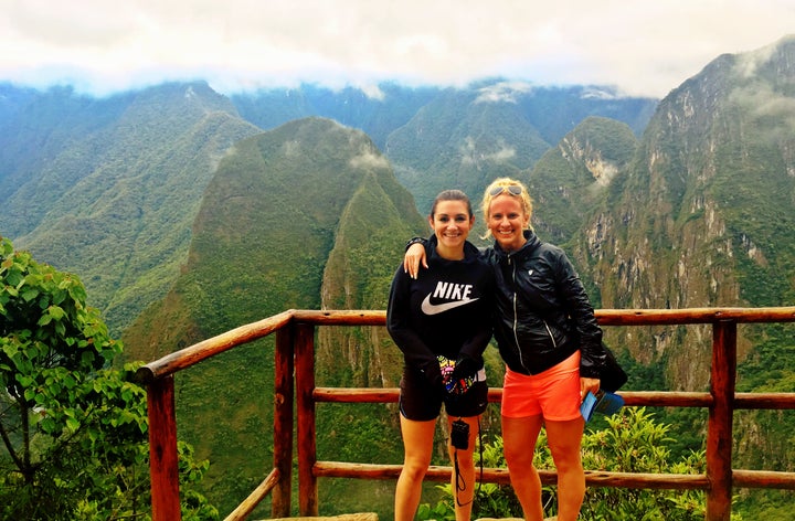 <p>Two female travelers at the entrance to Machu Picchu in Peru</p>