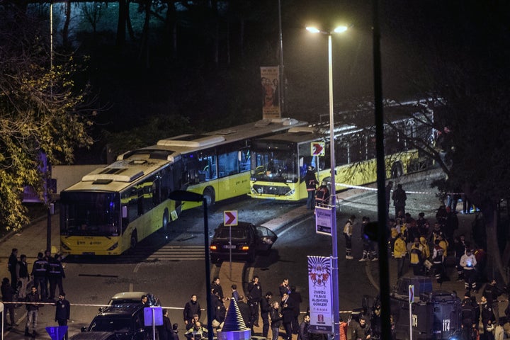 Turkish emergency workers, police officers and forensic work on the site where a car bomb exploded near the stadium of footba