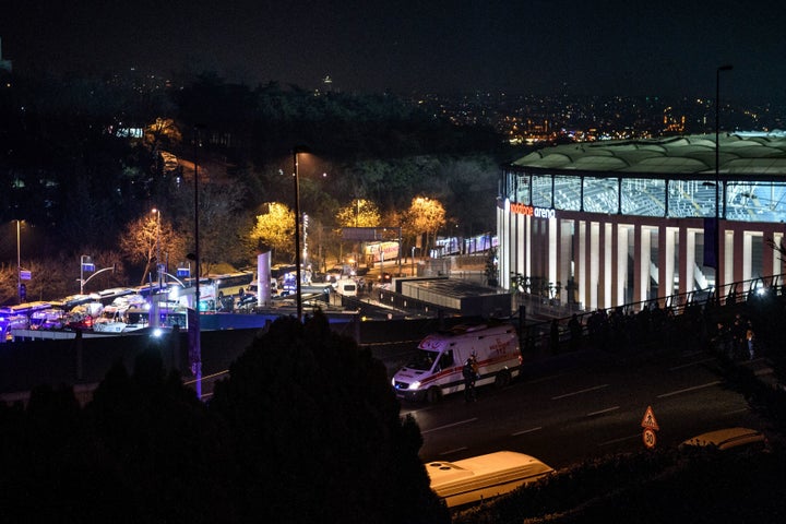 Turkish emergency workers, police officers and forensic work on the site where a car bomb exploded near the stadium of footba