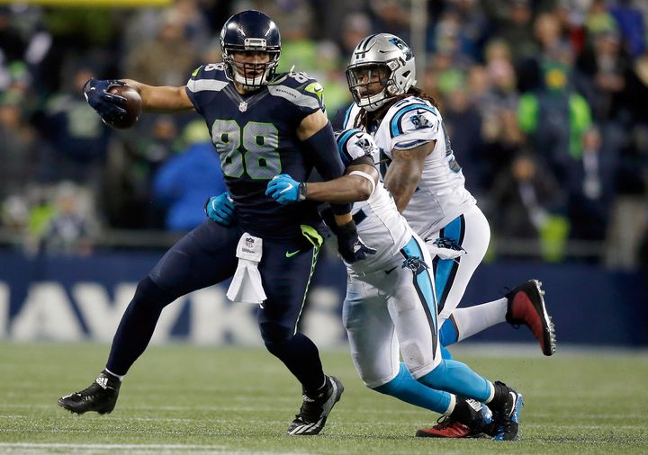 Just add guns? Seattle Seahawks' Jimmy Graham tries to break free against the Carolina Panthers at CenturyLink Field in Seattle early in December. A bill introduced in the Washington State Legislature would allow licensed firearms in sports stadiums.
