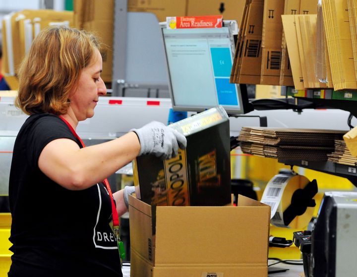 A worker packs an order at Amazon's Hemel Hempstead warehouse