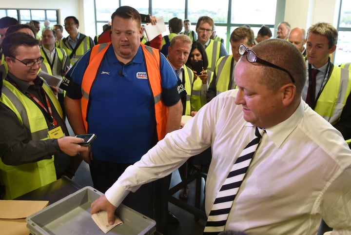 Sports Direct CEO Mike Ashley emptying wads of fifty pound notes during a PR tour of a warehouse