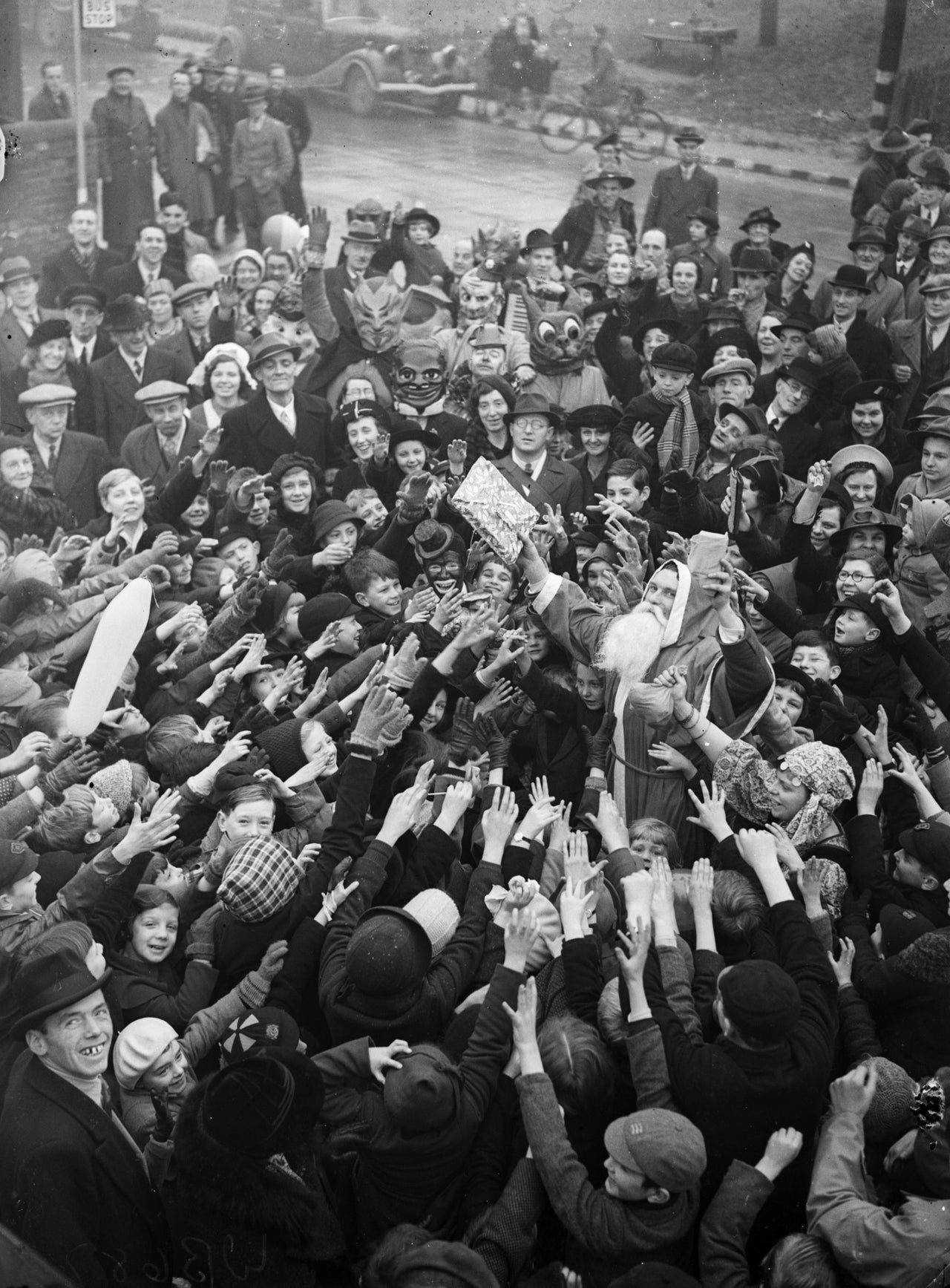 Father Christmas handing out presents to evacuees from Peckham in 1940.