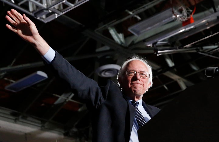 Democratic U.S. presidential candidate Bernie Sanders waves after winning at his 2016 New Hampshire presidential primary nigh