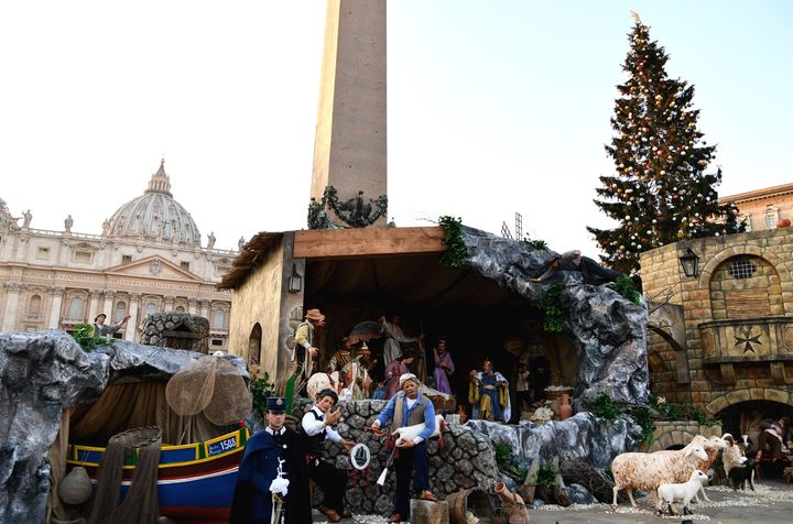 The Christmas tree (R) and the nativity scene (C) are pictured at the Saint Peter's square prior to the illumination ceremony on December 9, 2016 in Vatican. This year, the Christmas ornaments were made by children of the paediatric oncology departments of Italian hospitals