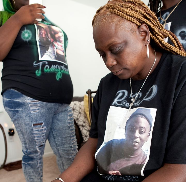 Members of Jamycheal Mitchell's family, wearing shirts with his photograph, pose for a portrait at the home of his aunt in Chesapeake.