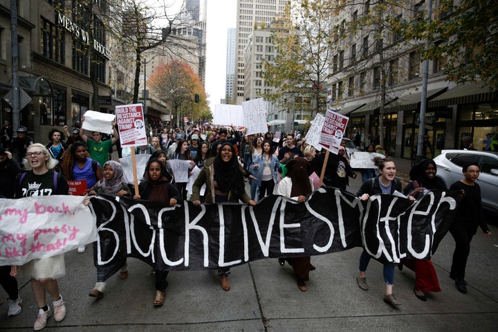 Protestors carry a "Black Lives Matter" banner in Seattle during a student walkout protest following Trump's election, Nov. 14, 2016.