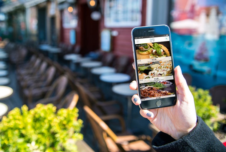 A phone displaying the FoodForAll app, showing the discounted food available.