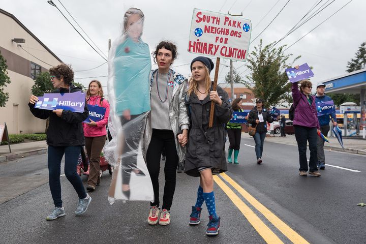 Shawna and Beezus guide the group down the 14th Ave South parade route on Sep. 17. The Clinton cardboard cutout was wrapped in plastic for rain protection
