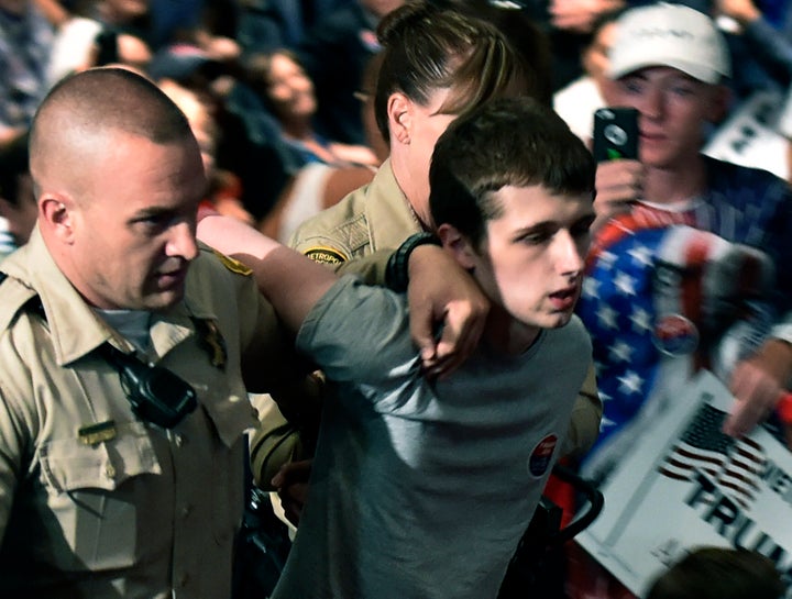 Las Vegas police lead Michael Sandford from the Trump's campaign rally in June.