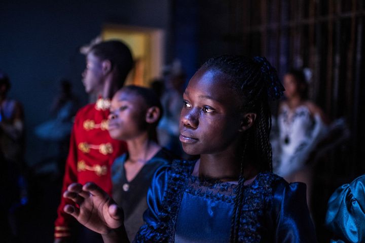 Pamela is watching and waiting for her turn to enter the stage during rehearsal at the national theatre in Nairobi.
