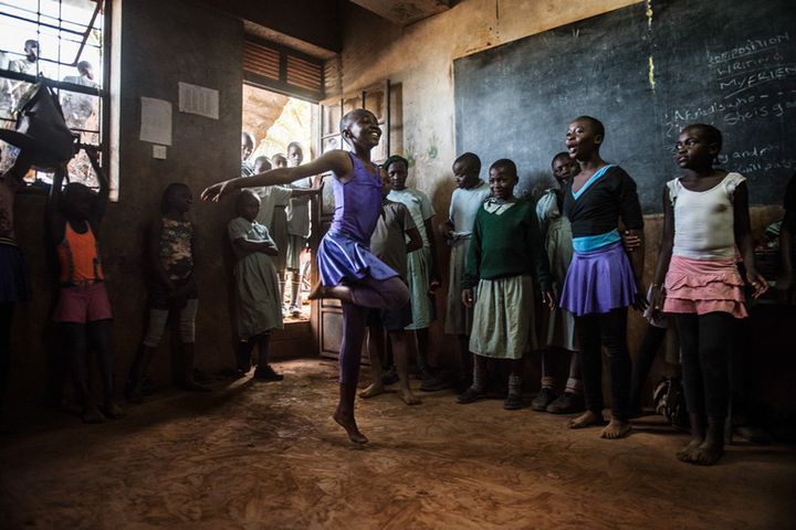 Wendy is practicing while the other students cheer for her. They each take turns and learn from one another.