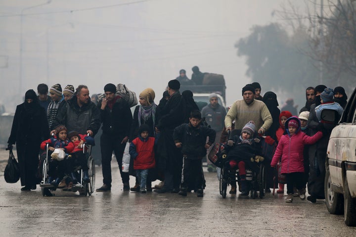 People walk as they flee deeper into the remaining rebel-held areas of Aleppo, Syria December 13, 2016.