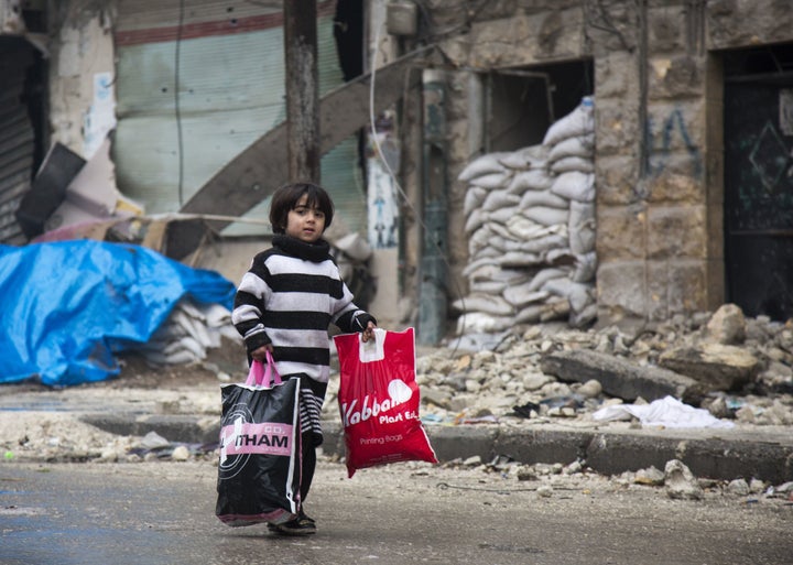 A Syrian boy is seen among other civilians leaving a rebel-held area of Aleppo towards the government-held side on December 13.