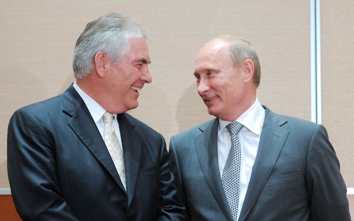 Russian Prime Minister Vladimir Putin (R) speaks with Exxon CEO Rex Tillerson at a signing ceremony in the Black Sea resort of Sochi August 30, 2011.