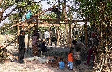 Villagers in rural Cambodia building a Christian community center that Dr. Kuy and her mother supports