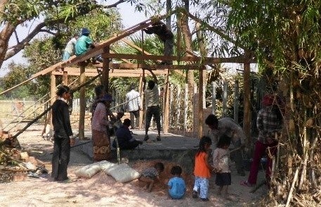 Villagers in rural Cambodia building a Christian community center that Dr. Kuy and her mother supports