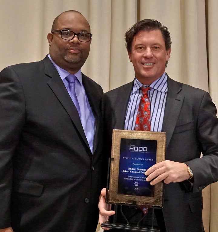 <p>Pastor Corey Brooks presents Strategic Partner Award to philanthropist Robert J. Semrad for support of Project HOOD at Standard Club, Chicago, Dec. 12, 2016</p>