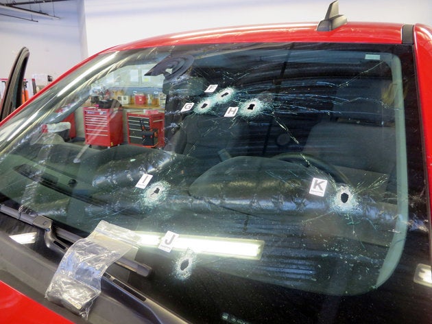 Bullet holes mark the windshield of the Chevrolet Silverado truck that Pedro Villanueva was driving when California Highway P