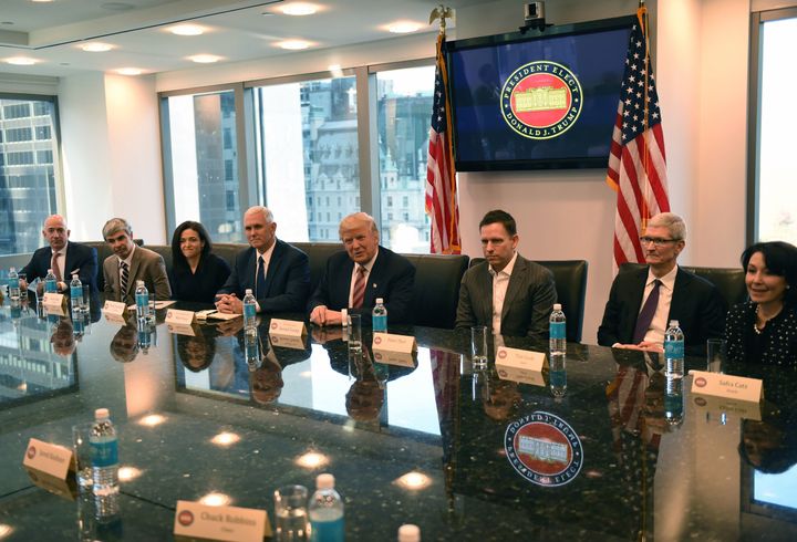 (L-R) Amazon's chief Jeff Bezos, Larry Page of Alphabet, Facebook COO Sheryl Sandberg, Vice President elect Mike Pence, President-elect Donald Trump, Peter Thiel, co-founder and former CEO of PayPal, Tim Cook of Apple and Safra Catz of Oracle attend a meeting at Trump Tower December 14, 2016 in New York. (TIMOTHY A. CLARY/AFP/Getty Images)