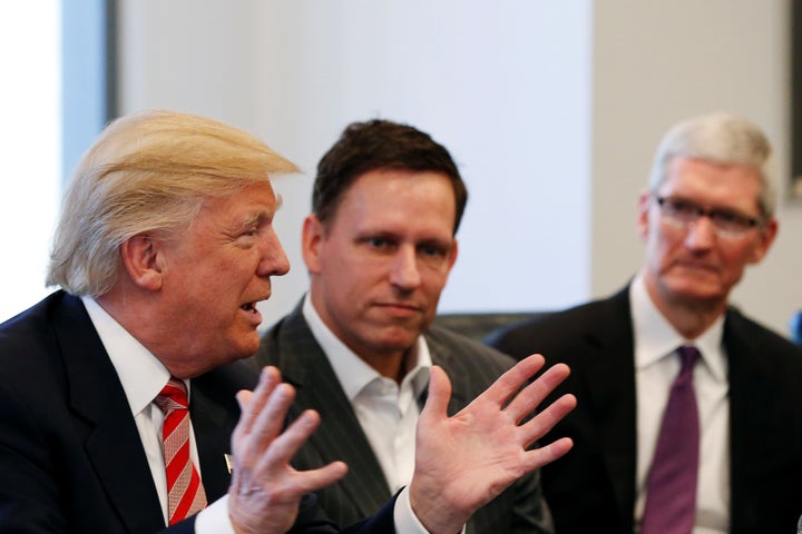 U.S. President-elect Donald Trump speaks as PayPal co-founder and Facebook board member Peter Thiel (C) and Apple Inc CEO Tim Cook look on during a meeting with technology leaders at Trump Tower in New York U.S., December 14, 2016. (REUTERS/Shannon Stapleton)