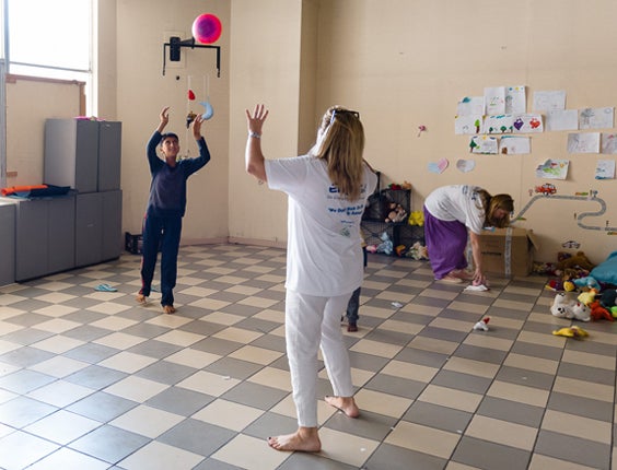 A humanitarian and a refugee find time to play.