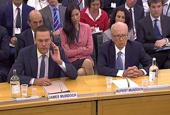 James Murdoch (left) and his father Rupert Murdoch giving evidence about phone hacking