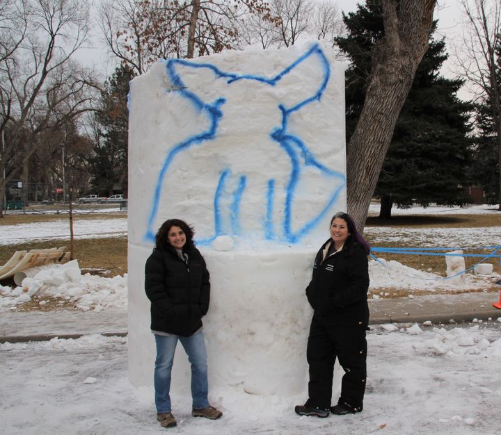 Harley’s “mom” Rudi Taylor (left) and Kerri Ertman (right) standing with, what will soon be, Snow Harley! 