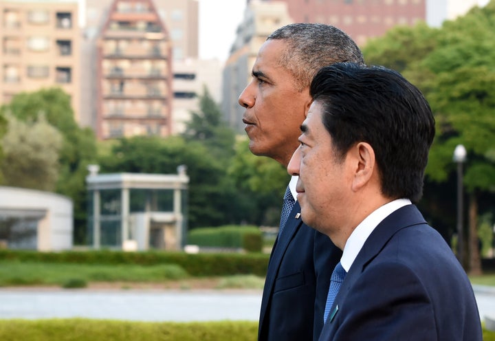 U.S. President Barack Obama and Japanese Prime Minister Shinzo Abe walk toward the Atomic Bomb Dome after laying a wreath in the Peace Memorial Park in Hiroshima on May 27, 2016.