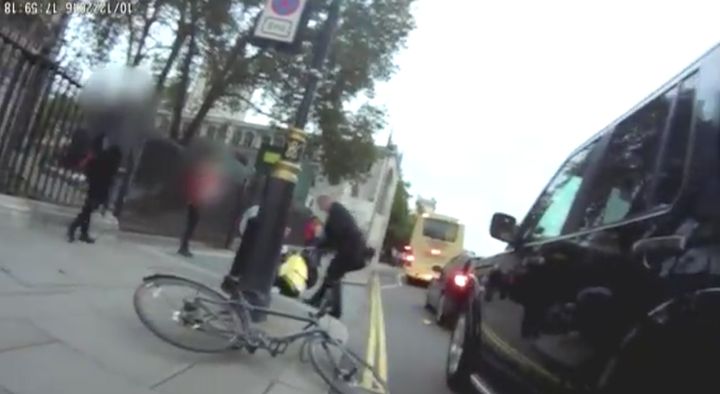 <strong>Grayling tends to the fallen cyclist.</strong>
