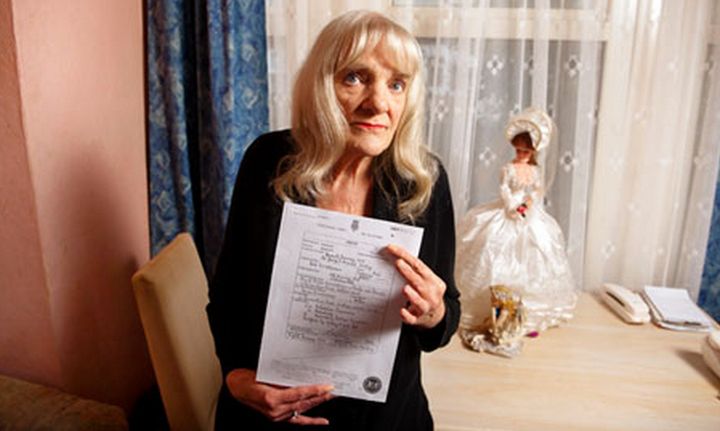 Barbara Shaw holds the death certificate for her son, Rod Richardson, whose identity an undercover police officer used