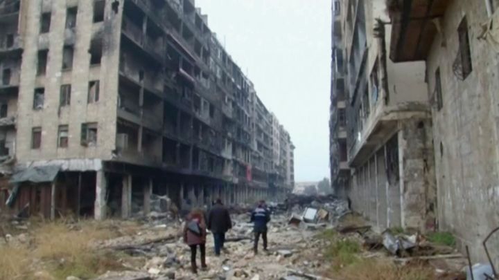 <strong>People walked through the destroyed streets of Aleppo on December 13.</strong>