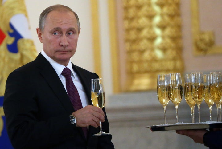 Putin takes a glass of champagne during the reception for new foreign ambassadors at the Grand Kremlin Palace. Nov. 9. Moscow.